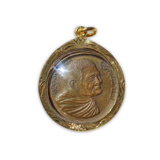 Close-up of a Thai LP Waen Suchinno amulet in a wooden casing