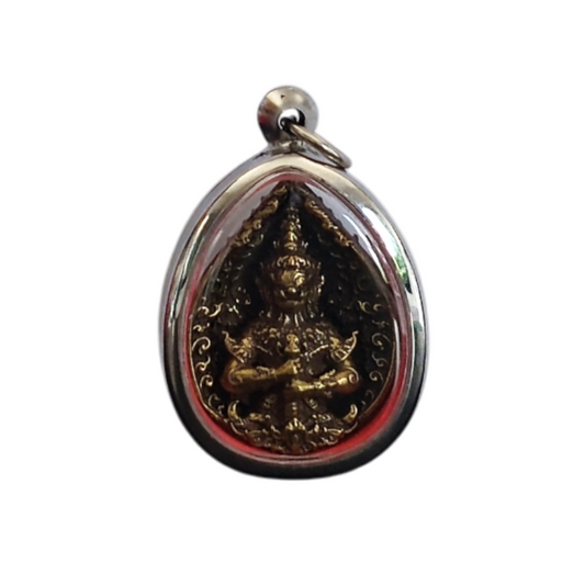 Close-up of a Thai Thao Wessuwanno amulet in a wooden casing