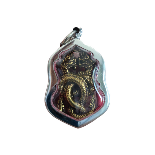 Vintage-style Phaya Naga Thai amulet with symbolic markings for protection and good fortune